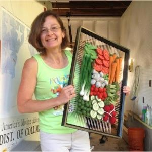 Martina Celerin holding 3D weaving of vegetables